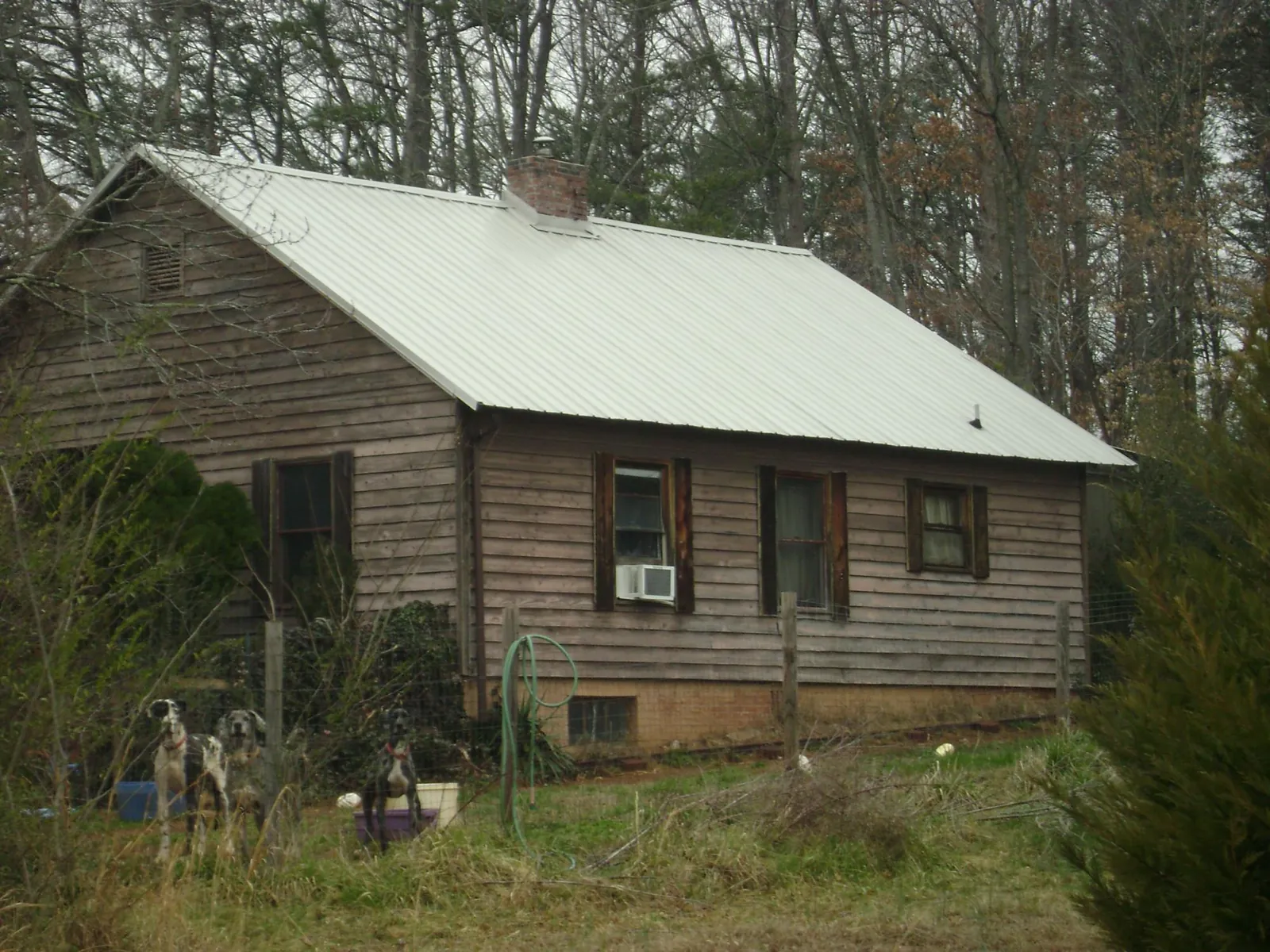 White metal roof on an old wood sided farmhouse, from a Metal Roof Installation job in Sycamore